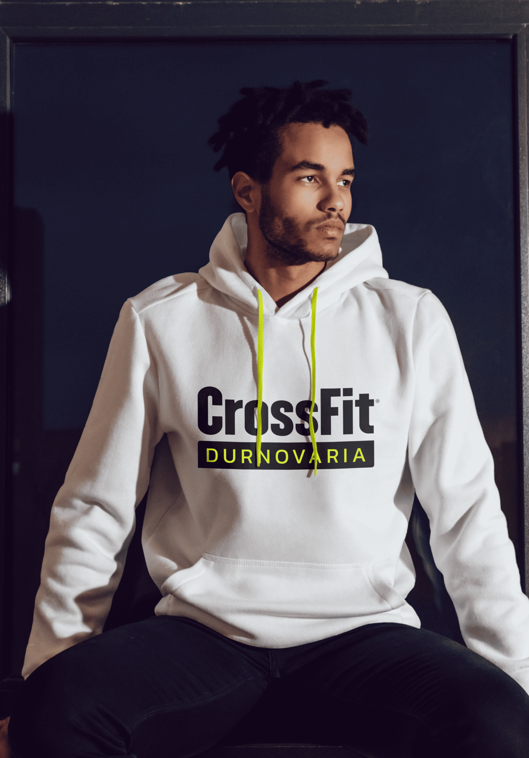 A man wearing a Crossfit Workout Active Hoodie sitting in a window in Dorchester, Dorset.